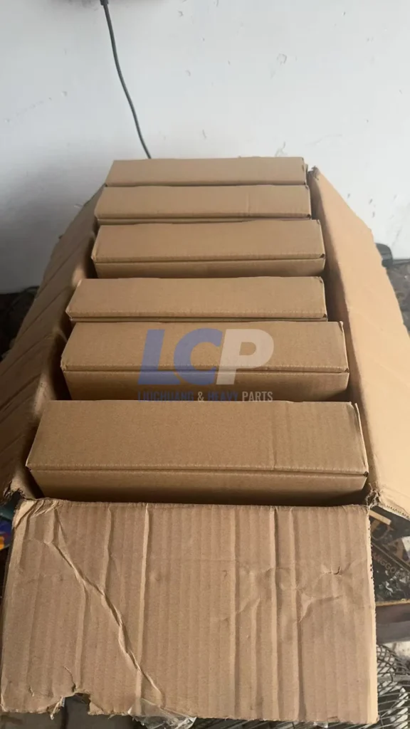 Six individually boxed Caterpillar 157-3705 ECMs arranged in open master shipping carton, bulk order for US fleet customer, each unit individually packaged