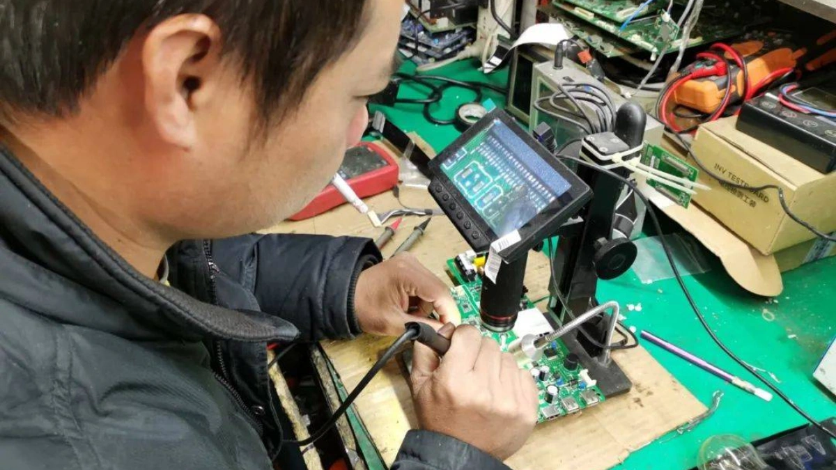 Technician performing board-level repair under microscope at LIUCHUANG Parts, Foshan